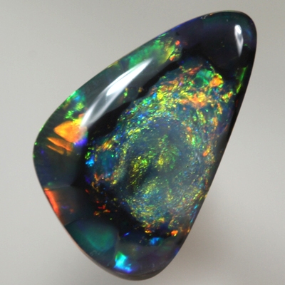 SOLID BLACK OPAL  Unusual pattern, nubular centre surrounded by rolling flashes